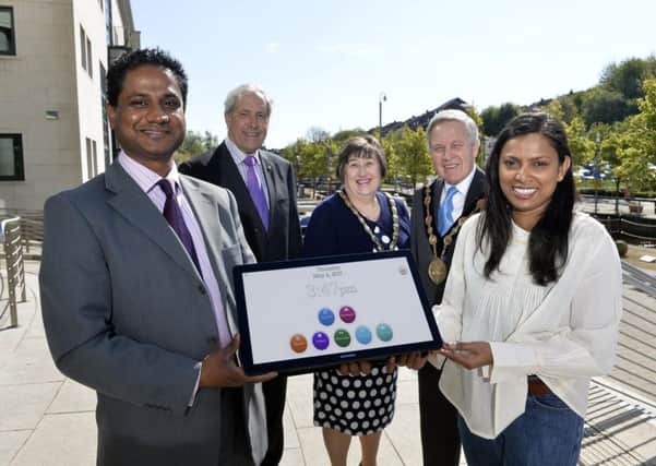 Deepak and Preetiy Samson showcase the innovative touchsreen 'Ethel'  with the Chairman of Lisburn & Castlereagh City Council's Development Committee, Councillor Uel Mackin; the Mayor, Councillor Brian Bloomfield MBE and Mayoress, Mrs Rosalind Bloomfield.