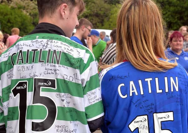 Remembering Caitlin with Celtic and Rangers shirts. INPT21-236.