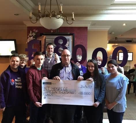 Phillip, Laura and Kevin Diamond with family and friends presenting the cheque to Michael Nugent, community fundraiser and Kilrea Hospice Support Group.