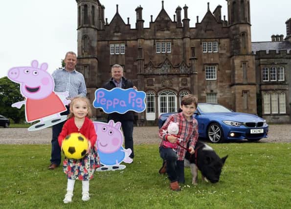 Martha the pig, nine-year-old Tyler Campbell from Glenarm and three-year-old Soley Laverty from Belfast. Also pictured are Roy Webb and Andrew McCann from CarNET Car Sales.