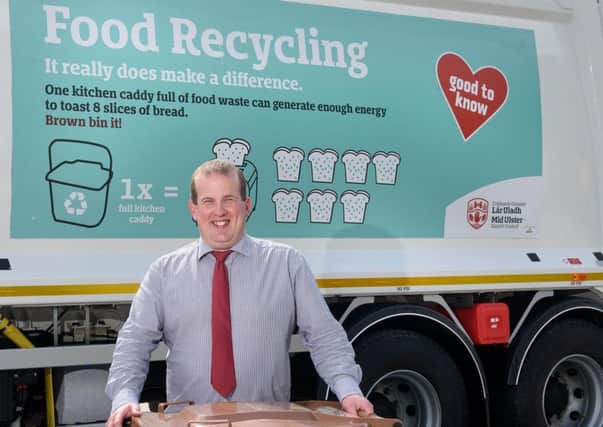 The Chair of the Environment Committee, Councillor Clement Cuthbertson is pictured with one of the bin lorries carrying the new messaging