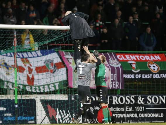 Glentoran players help  fix the net during October's Irish Cup tie against rivals Linfield. Photo: Press Eye