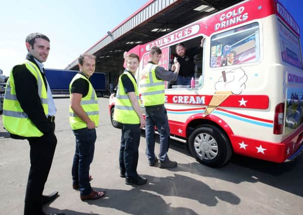 Employees at SDC Trailers outside Toome cool down with ice-cream from an ice-cream van put on by the management this afternoon.

Picture by Jonathan Porter/PressEye.com