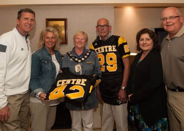 Mid&East Antrim Mayor Audrey Wales and Chris Wales receive a presentation of football jerseys from of Danville Centre College American tootball team head coach Andy Frye, Cindy Frye, Rickie Gay, and former Danville City Commissioner Jamie Gay, on their visit to Carrickfergus.