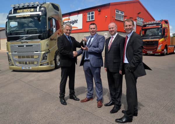 Pictured at the handing over of a special limited edition Volvo truck to Manfreight are, from left, Arne Knaben, MD, Volvo Group, UK and Ireland, Chris Slowey, MD, Manfreight, John Jenkins, MD, Dennison Commercials, and Rob Ireland, sales director, Dennison Commercials. INPT22-205.