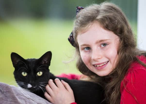 Faith Downey (11) with her cat Mittens. Pic: Cats Protection/PA Wire