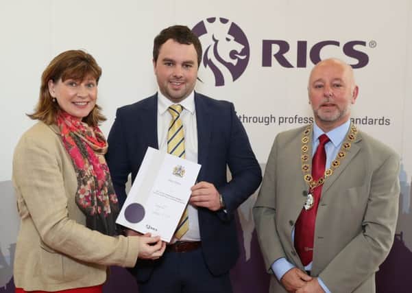 Adam Bolton receives his diploma from Fiona Grant, RICS UK & Ireland Chair and Andy Tough FRICS, Chair of RICS Northern Ireland.