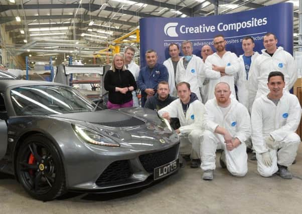 The Creative Composites team responsible for manufacturing the Lotus parts pose for a picture with the Lotus Exige Sport 350.