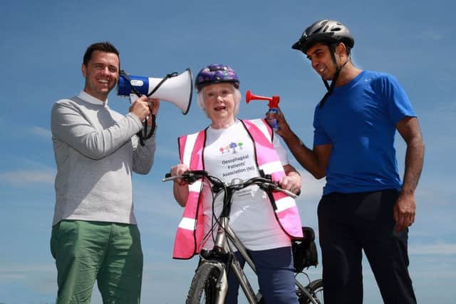 Cool FM's Pete Snodden and Dr Inder Mainie giving sound support to Helen Setterfield, chairperson of the Osophageal Patients Association (NI). The charity is holding a 110 mile Cycle Challenge from Carrickfergus Castle to Ballycastle and back on June 17th and 18th. Picture Bill Smyth.