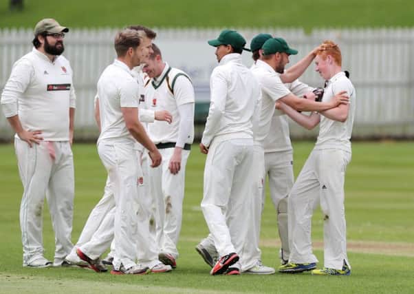 Fifteen year old Nathat Doak (right) is contratulated by his team mates after taking the wicket of North Down's Eakin