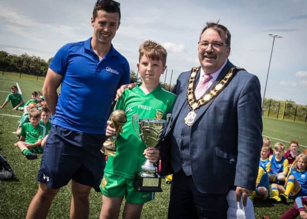 The Mayor, Antrim and Newtownabbey Borough, Councillor John Scott, presenting player of the tournament with his trophy Shea McAuley, St Comgalls Primary school, Antrim. Antrim and Newtownabbey Borough Council, Every Body Active Football Coach, Samuel McIlveen initiated the league.