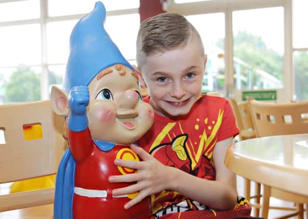 Superhero fan Oliver Dickey with Supergnome he received at a special presentation by Asda colleagues during his visit to the Coleraine Asda store