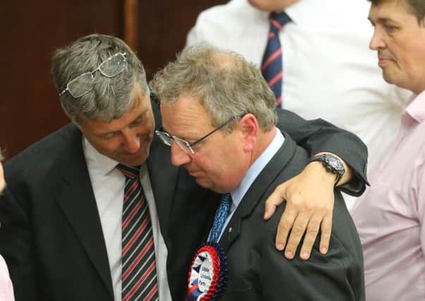 Paul Girvan consoles Danny Kinahan at the Vally Leisure Centre count venue