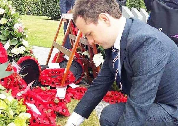 Cllr Andrew Wilson lays a wreath on behalf of Mid and East Antrim Borough.