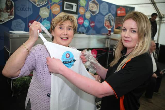 Shauna McFaul gets the Mayor Councillor  Maura Hickey geared up for the event the Can't Cook, Won't Cook event at the Rathlin Sound Maritime Festival at Ballycastle. Picture: Kevin McAuley/McAuley Multimedia