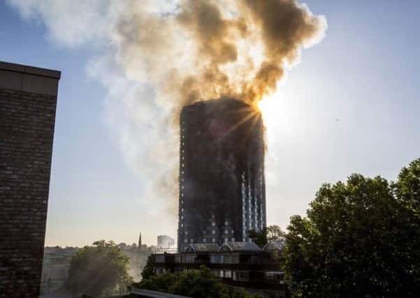 Smoke billows from a fire that has engulfed the 27-storey Grenfell Tower in west London