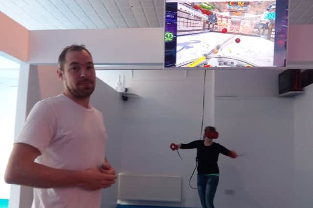 Chris Canavan with his sister who is playing one of the virtual reality games at Centrepoint in Lurgan