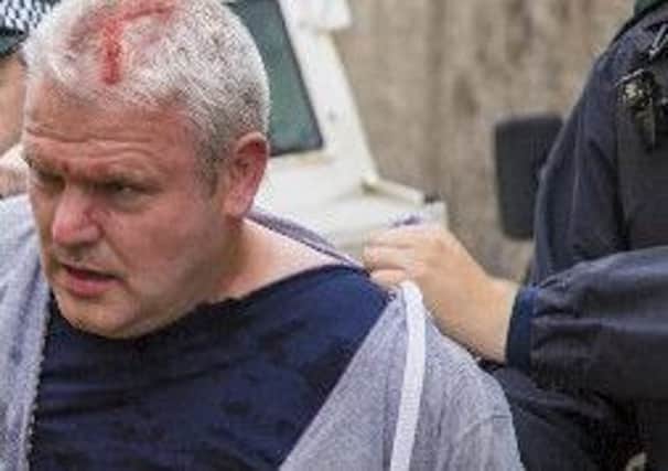 Cllr Padraig McShane is arrested by PSNI during the Twelfth demonstration in Ballycastle after an altercation with Dervock Band.