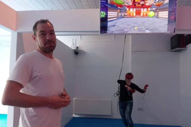 Chris Canavan with his sister who is playing one of the virtual reality games at Centrepoint in Lurgan