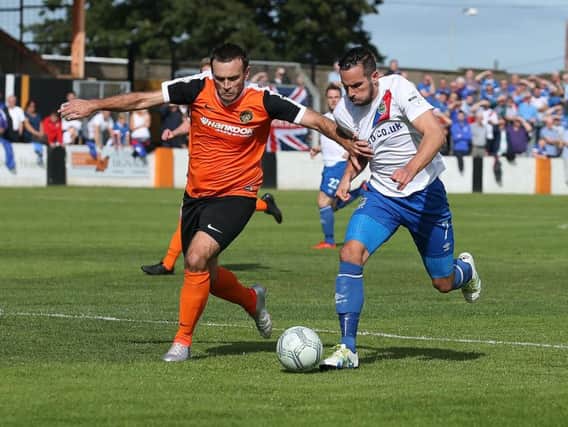 Glenn Taggart keep track of Linfield striker Andy Waterworth at Taylor's Avenue