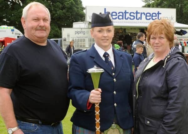 Alicia Hamilton nee Dickson (middle) has been awared the British Empire Medal, she is pictured with her parents Geoffrey and May, whom she has thanked for their support.