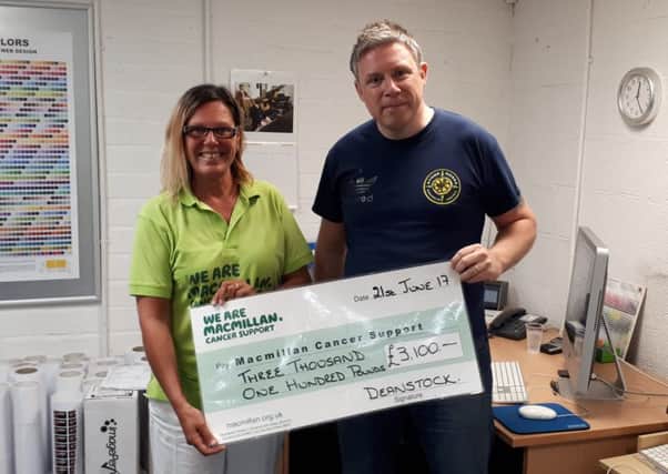 Dean Sinclair presents Joanne Long from MacMillan with a cheque for Â£3,100.