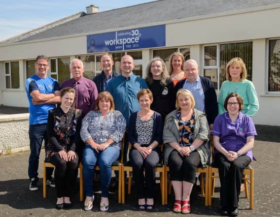 Catherine McCoy, Workspace (front row, center) with representatives from local community and voluntary groups who recently received grants from the Workspace Community Fund.