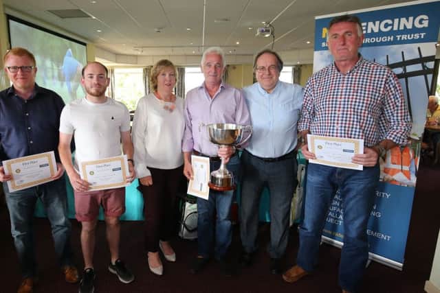 The winning team from Manvik are presented with their trophy by Jennifer Davidson; from left,  Michael Keys, Christopher Wadsworth,  Jennifer Davidson, John Connor, MD of Manvik, Colum McCarthy, president of Carrickfergus Rotary Club and Davy Duffy. INCT 26-755-CON
