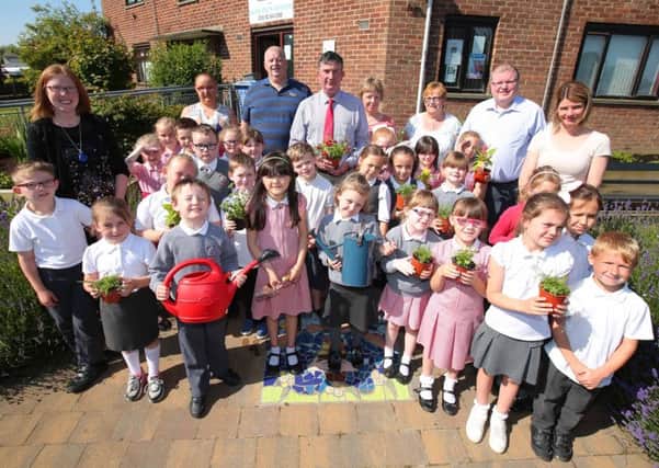 Pictured at the community garden in Hilden with Councillor James Baird, former Chairman of the council's Environmental Services Committee, are: the RHS School Champions - Fort Hill Integrated Primary School (represented by P3 pupils and their teachers); Sharon McMaster, RHS Champion 2016; Roberta Mitchell, NI Housing Executive; representatives of Hilden Community Association and Councillor Jonathan Craig.