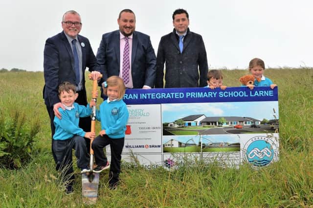 Corran Integrated nursery pupils, Tobias and Molly cut the first sod of their new primary school with David, Yasmin and acting principal, Mr Furey, Chaiir of the Board of Governors, Neil Clarke and Mark Currie MD of Donaghmore Construction who will build the school. INLT 27-001-PSB