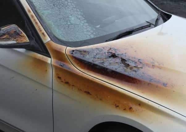 Damage to a BMW car parked beside a van which was destroyed in an arson attack at Glenavon Crescent.