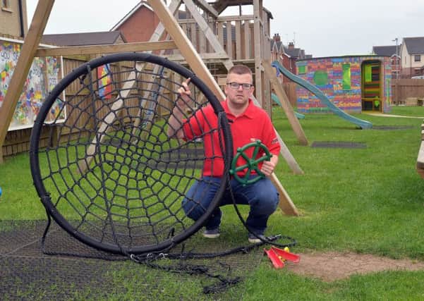 Gordon Woolsey pictured with some of the broken play equipment at Scotch St Play Park. INPT26-232.