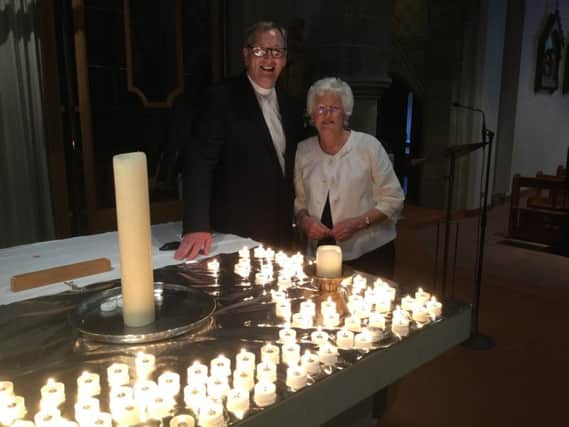 Pat Crossley and Guest Speaker Very Rev Frank Sellar beside some of the candles for Peace.