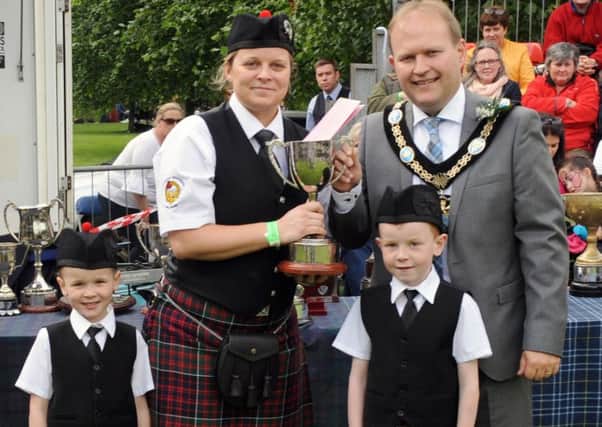 Pipe Sergeant Sonya Rooney (McDonald Memorial Pipe Band) and her daughter Billie and son Samuel pictured receiving the Grade 4A All-Ireland Champions trophy from Lord Mayor, Alderman Gareth Wilson (Chieftain of the Day) at the All-Ireland Pipe Band Championships at Lurgan Park on Saturday 1st July. Pic by John Kelly