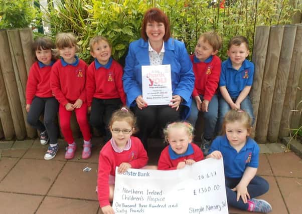 Children from Steeple Nursery School present their cheque for Â£1360 to Sharon Gorman, Donor Development Officer, Northern Ireland Childrens Hospice