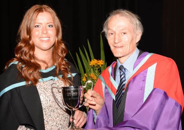 Chloe McIlwaine receiving her award from Dr Clifford Boyd.