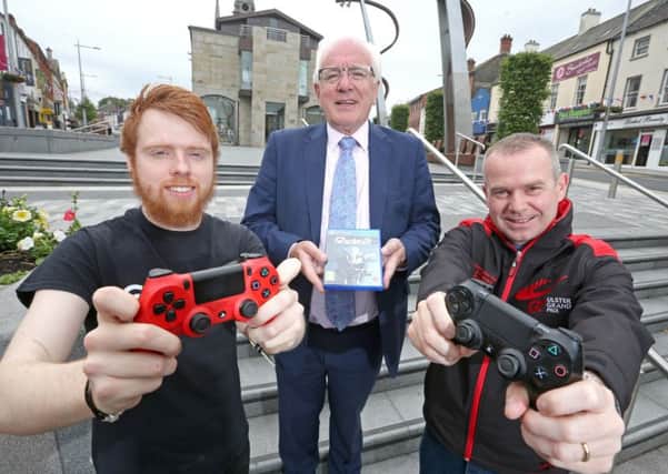 Cormac Mullan (left), Store Manager at Game, Lisburn; Alderman Allan Ewart MBE, Chair of the Development Committee at Lisburn & Castlereagh City Council; and Geoff Wilson (right), Brand Manager for the MCE Ulster Grand Prix.