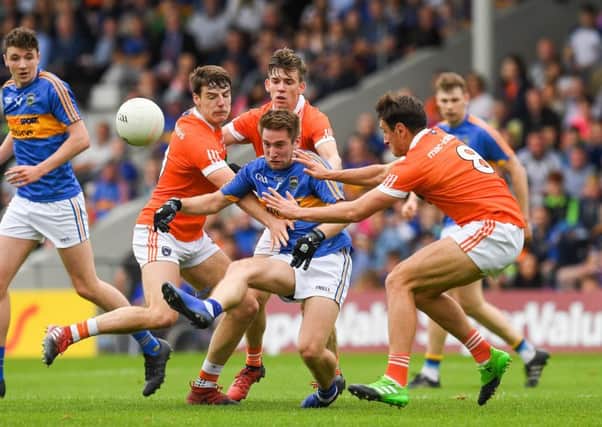 Bill Maher of Tipperary in action against, from left, Niall Grimley, Paul Hughes and Stephen Sheridan of Armagh
