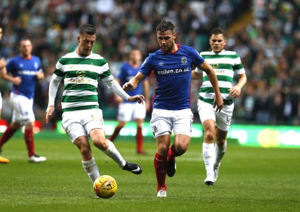 Callum McGregor of Celtic and Stephen Lowry of Linfield during the Champions League Second qualifying round match between Celtic and Linfield