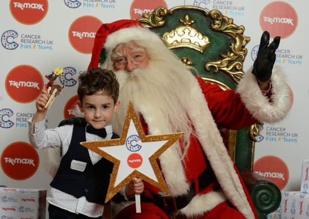 Henry Thompson pictured with Santa. Pic by Darren Cool www.dcoolimages.com.