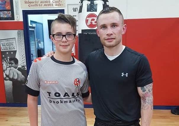 Frampton engaged with young boxers at the club.