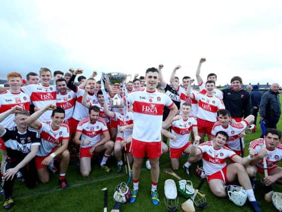 Derry celebrate winning the Ulster Under 21 title along with their captain Ciaran Steele.
