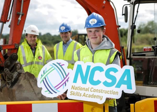 Eoin McDowell (16) from Lurgan gets ready for the first term of the new National Construction Skills Academy at Industry Training Services (ITS) in Portadown with Terry McCrum, Morrow Contracts, and Brendan Crealey, ITS. INPT31
