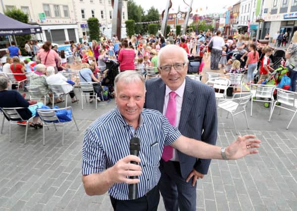 Chair of the Councils Development Committee, Alderman Allan Ewart MBE with entertainer Housty at Market Square.