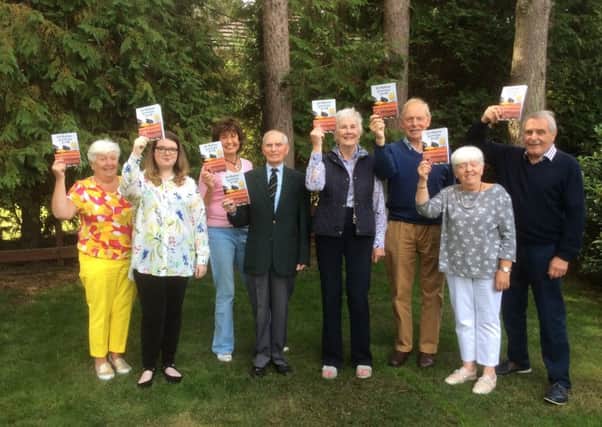Members of Portadown Gardening Society with the anniversary booklet.