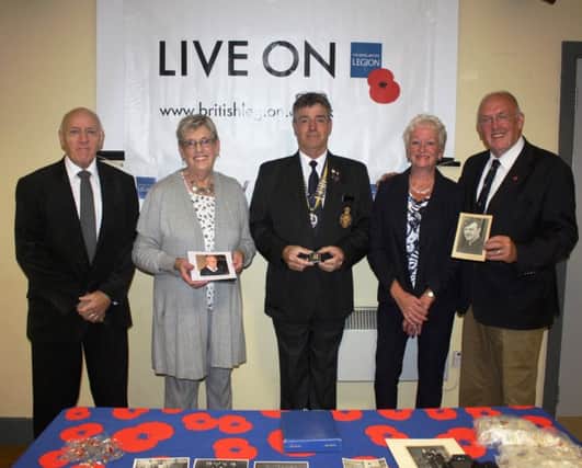 A poppy pin in honour of Sandy McGregor, former president of Whitehead Royal British Legion, has been commissioned. Pictured with Bill Dornan, chair of Whitehead RBL (centre), at the launch are members of Sandy's family, Hilton McGregor, Paddy Hull and Linda and Brian McGregor.