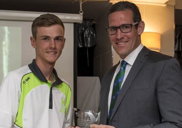 Player of the Tournament, Ireland's Graham Kennedy, receives his trophy from Ed Shuttleworth of the ICC.