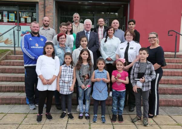Yvonne Craig (PCSP), Adrian Bird (Resurgam Trust), Alderman Michael Henderson MBE (PCSP Chairman) and Chief Inspector Lorraine Dobson (PSNI) with ethnic minority families at the `Food for Thought` event held recently at Laganview Enterprise Centre, Lisburn.