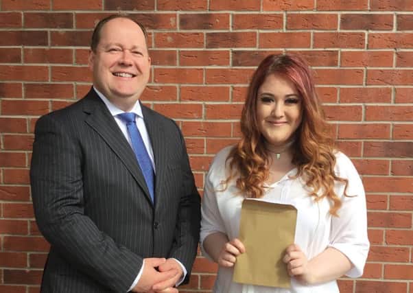 Mr. Houston, principal of Ulidia Integrated College, congratulates top performing pupil Megan White on attaining two A* and two As at A Level.