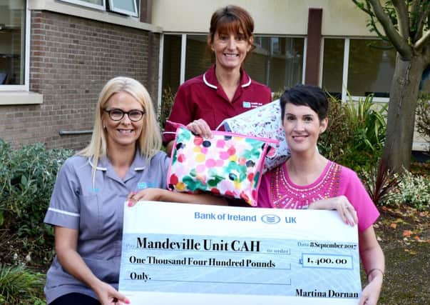 Martina Doran presents the chemo care packs and a cheque to staff from Craigavon Area Hospital. INPT39